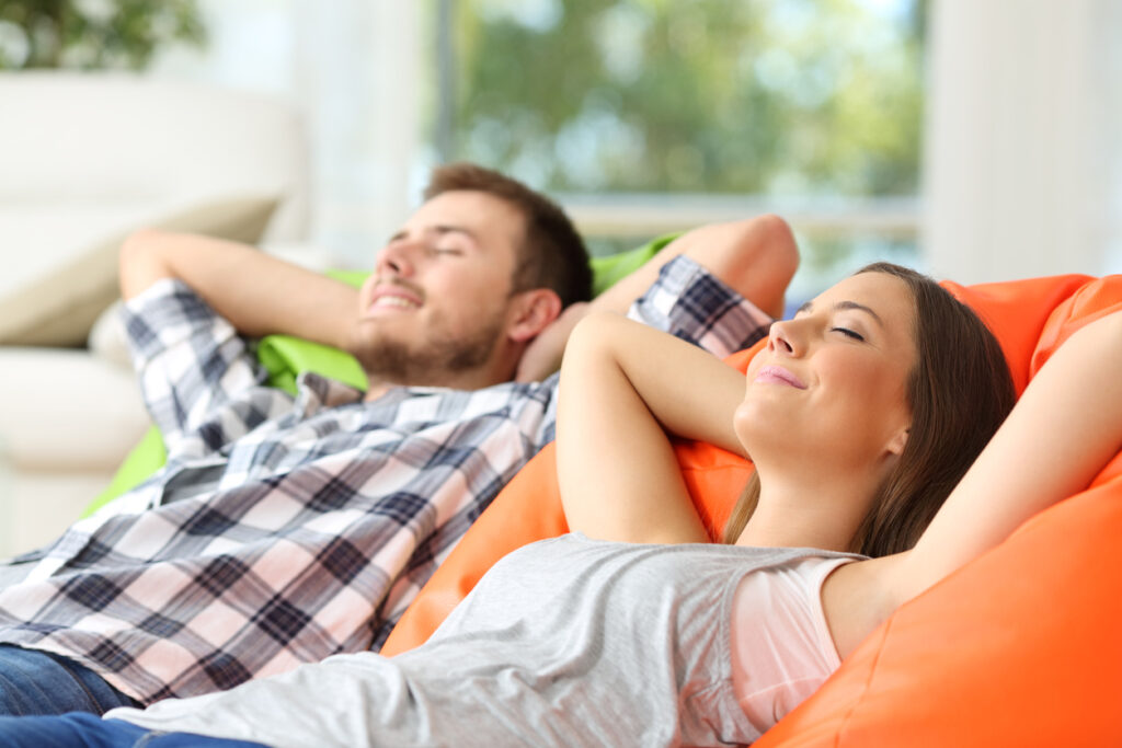 Couple or roommates relaxing at home