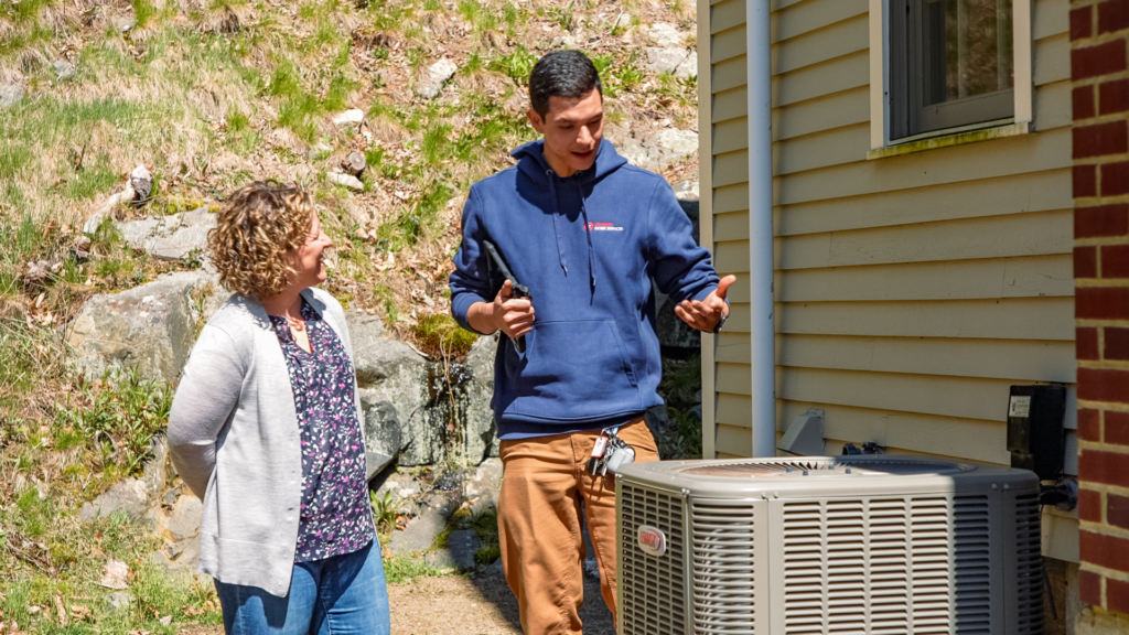 Cranney technician discussing air conditioner options with a homeowner.