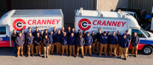 The Cranney team lined up in front of Cranney service vans