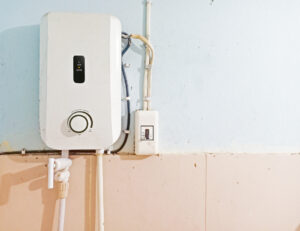 White instant water heater installed with circuit breaker on the wall of bathroom
