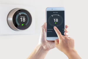Homeowner adjusting smart thermostat setting